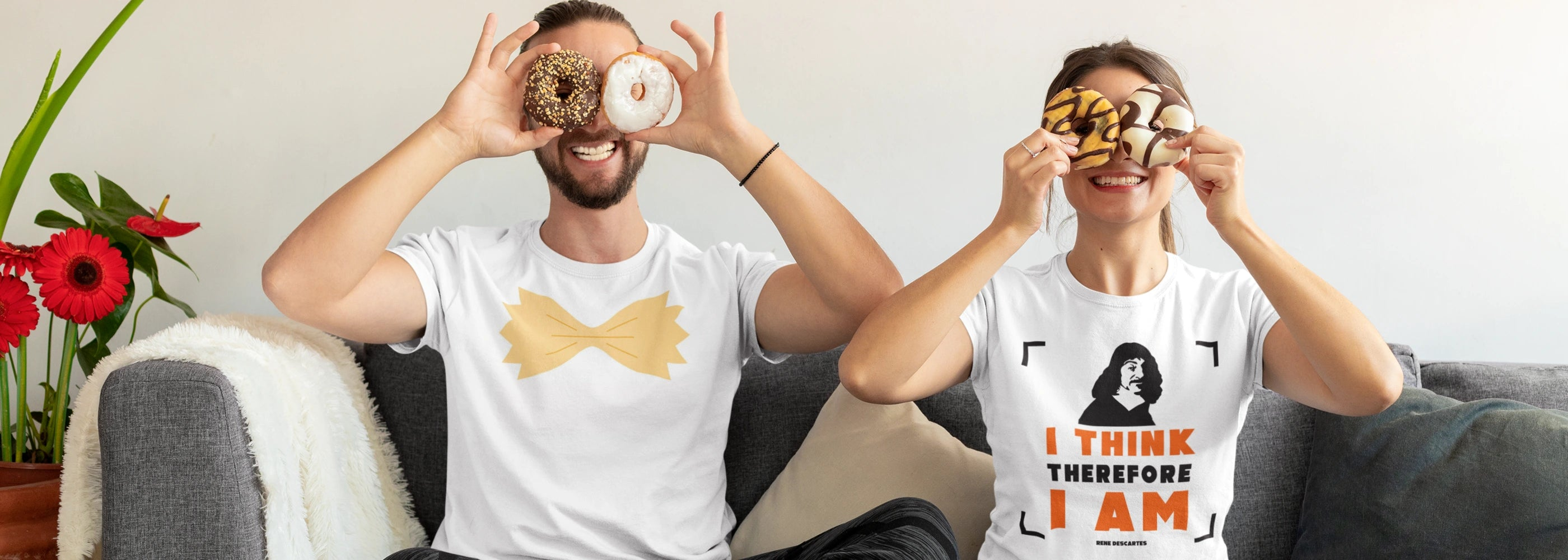 Man and woman wearing t-shirts: one featuring a playful pasta design, and the other with an inspiring quote, styled casually to showcase unique, expressive prints