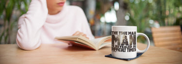 A mug on a desk with a quote printed on it.