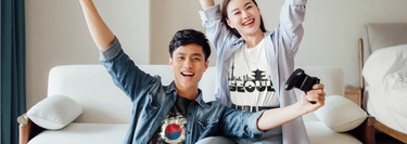 Man and woman wearing unisex t-shirts featuring South Korea's flag and Seoul-inspired designs.