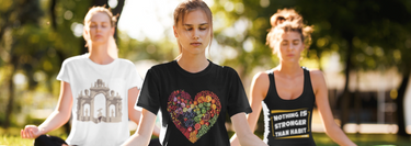 Three women, two wearing unisex t-shirts and one wearing a tank top, each with different designs.