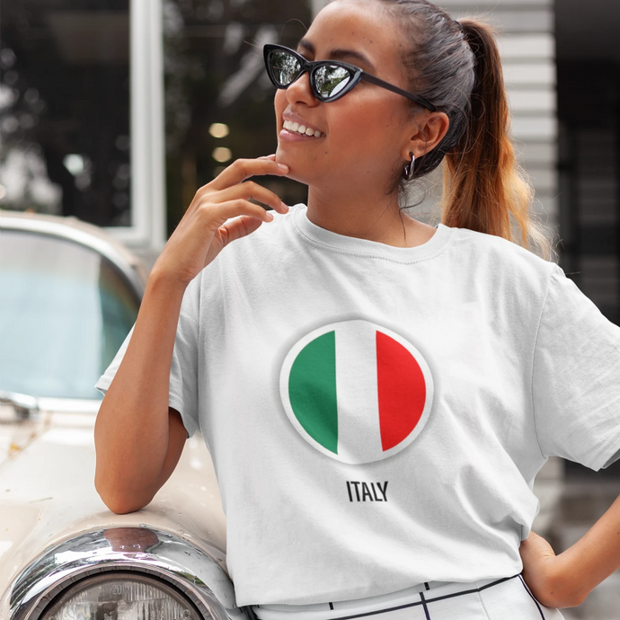 A girl wearing a white t-shirt with the design of Italy's flag, featuring green, white, and red vertical stripes.