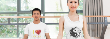 Man wearing a t-shirt and woman wearing a tank top, both featuring Chinese prints, styled casually to showcase cultural designs with a modern touch.